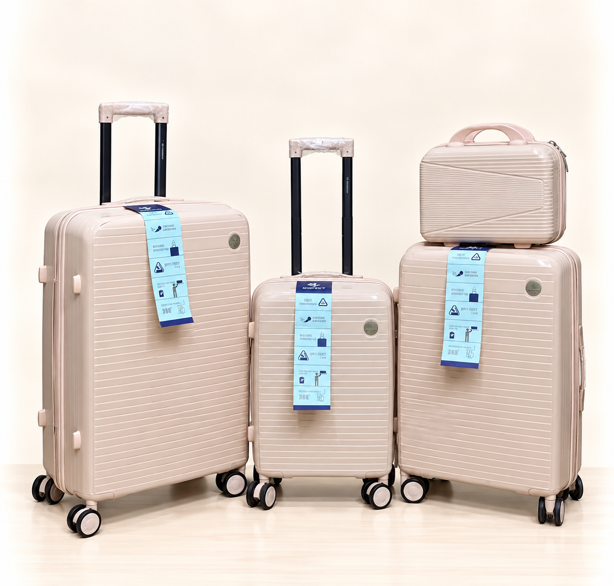 A three-piece pink luggage set consisting of a large spinner suitcase, a medium spinner suitcase, and a matching small handbag, all with telescoping handles and wheels, shown on a light beige background. 