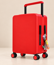 A bright red hard-shell spinner suitcase with a telescoping handle extended and black wheels, shown on a clean beige studio background.