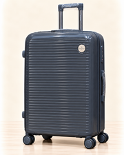 A three-piece pink luggage set consisting of a large spinner suitcase, a medium spinner suitcase, and a matching small handbag, all with telescoping handles and wheels, shown on a light beige background. 
